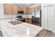 Modern kitchen with stainless steel appliances and light wood cabinets at 631 Bentley North Dr, Auburndale, FL 33823