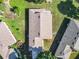 Aerial view of the home showcasing the roof, landscaping, and neighboring properties at 665 Lake Clark Pl, Lakeland, FL 33813