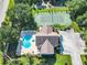 Overhead view of community amenities: pool, tennis court, clubhouse, and parking at 665 Lake Clark Pl, Lakeland, FL 33813