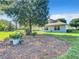 Beautiful backyard with a large tree and landscaping features offering shade and charm at 665 Lake Clark Pl, Lakeland, FL 33813