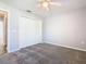 Bedroom featuring neutral gray walls, ceiling fan, and carpeted floor at 665 Lake Clark Pl, Lakeland, FL 33813