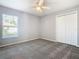 Bedroom with gray walls, ceiling fan, and closet with double doors at 665 Lake Clark Pl, Lakeland, FL 33813