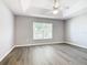Bright bedroom showcasing a large window and wood-look flooring at 665 Lake Clark Pl, Lakeland, FL 33813