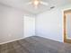Bedroom with double door closet, ceiling fan, and neutral-colored walls and carpet at 665 Lake Clark Pl, Lakeland, FL 33813
