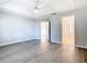 Spacious bedroom features tray ceilings, a ceiling fan, and wood-look flooring at 665 Lake Clark Pl, Lakeland, FL 33813