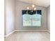 Bright dining area with large window and modern chandelier at 665 Lake Clark Pl, Lakeland, FL 33813