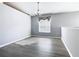 Bright dining area with gray walls, new flooring, a modern light fixture, and natural light from the window at 665 Lake Clark Pl, Lakeland, FL 33813