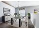 Dining room showcases a glass table, white chairs, and modern decorations at 665 Lake Clark Pl, Lakeland, FL 33813