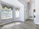 Bright entryway featuring wood-look flooring, gray walls, a decorative front door, and natural light from the windows at 665 Lake Clark Pl, Lakeland, FL 33813