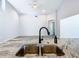 Kitchen sink with granite countertops and black faucet overlooks spacious open floor plan at 665 Lake Clark Pl, Lakeland, FL 33813