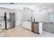 Open kitchen boasts stainless steel appliances, center island, and white cabinets at 665 Lake Clark Pl, Lakeland, FL 33813