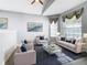 Cozy living room with neutral furniture, a glass coffee table, and ample natural light from the windows at 665 Lake Clark Pl, Lakeland, FL 33813