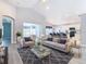 Open-concept living room with modern decor, high ceilings, seamless flow to the kitchen, and lots of natural light at 665 Lake Clark Pl, Lakeland, FL 33813