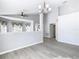 Inviting living space featuring wood-look floors, gray walls, large windows, and a half wall for separation at 665 Lake Clark Pl, Lakeland, FL 33813