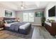 Main bedroom with tray ceilings, ceiling fan and luxury furnishings at 665 Lake Clark Pl, Lakeland, FL 33813