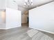 Large open living area with neutral gray walls and vinyl plank flooring, illuminated by natural light at 665 Lake Clark Pl, Lakeland, FL 33813