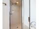 Glass-enclosed shower with hexagon tile floor and shower head at 665 Lake Clark Pl, Lakeland, FL 33813