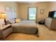 Bright bedroom with a king-size bed and window views at 107 Pine Rustle Ln, Auburndale, FL 33823