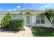 House entrance with gray door and lush landscaping at 107 Pine Rustle Ln, Auburndale, FL 33823