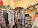 Well-organized walk-in closet with hanging rods and shelves at 107 Pine Rustle Ln, Auburndale, FL 33823