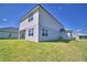Rear exterior of home showcasing a grassy yard at 4538 Grandview Glen Dr, Auburndale, FL 33823