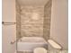Clean bathroom featuring a bathtub with a tiled shower and neutral walls at 4538 Grandview Glen Dr, Auburndale, FL 33823