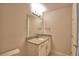 Neutral bathroom features a granite vanity, large mirror, and tile flooring at 4538 Grandview Glen Dr, Auburndale, FL 33823