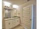 Bathroom featuring a double vanity with granite countertop and a tiled shower at 4538 Grandview Glen Dr, Auburndale, FL 33823