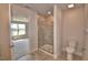 Bathroom featuring tiled floors, a glass shower, and a toilet, with a view into the bedroom at 4538 Grandview Glen Dr, Auburndale, FL 33823