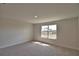 Bedroom featuring neutral walls, carpet flooring, and a window with a view of palm trees at 4538 Grandview Glen Dr, Auburndale, FL 33823