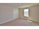 Bright bedroom featuring neutral walls, carpet, a window, and a closet with panel doors at 4538 Grandview Glen Dr, Auburndale, FL 33823