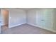 Bedroom with neutral walls and carpet flooring featuring doors to a closet at 4538 Grandview Glen Dr, Auburndale, FL 33823