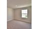Bedroom with neutral paint and carpet features natural light from a large window at 4538 Grandview Glen Dr, Auburndale, FL 33823