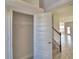 Bright entryway featuring tile floors, a convenient coat closet, and easy access to the home's staircase at 4538 Grandview Glen Dr, Auburndale, FL 33823