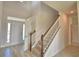 Bright entryway featuring a staircase with wood and white balusters at 4538 Grandview Glen Dr, Auburndale, FL 33823