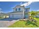 Charming two-story home boasts a three-car garage, well-kept lawn, and delightful curb appeal at 4538 Grandview Glen Dr, Auburndale, FL 33823