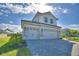 Lovely home featuring a well-maintained lawn, a three-car garage, and a brick paved driveway at 4538 Grandview Glen Dr, Auburndale, FL 33823