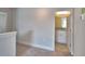 Upstairs hallway leading to a bathroom with vanity and granite countertops at 4538 Grandview Glen Dr, Auburndale, FL 33823