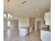 Open-concept kitchen with granite countertops, stainless steel appliances, and wood-look tile flooring throughout the home at 4538 Grandview Glen Dr, Auburndale, FL 33823