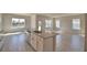 Open-concept kitchen with granite countertops, stainless steel appliances, and seamless flow to dining and living areas at 4538 Grandview Glen Dr, Auburndale, FL 33823