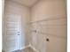 Utility room features modern washer and dryer hookups and a wire shelf for storage above the appliances at 4538 Grandview Glen Dr, Auburndale, FL 33823
