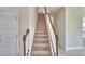 Carpeted staircase with decorative wood banister at 4538 Grandview Glen Dr, Auburndale, FL 33823