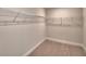 Walk-in closet with carpet flooring and shelving unit at 4538 Grandview Glen Dr, Auburndale, FL 33823