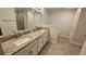 Bathroom with double vanity, granite countertop, and tiled floors at 4544 Grand View Glen Dr, Auburndale, FL 33823