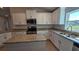 Modern kitchen with granite countertops, stainless appliances, and center island at 4544 Grand View Glen Dr, Auburndale, FL 33823