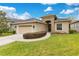 One-story house with stone accents, two-car garage, and manicured lawn at 6021 Stoney Creek Pl, Lakeland, FL 33811