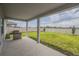 Covered patio with grill and fenced backyard at 296 Spirit Landings Cir, Winter Haven, FL 33880