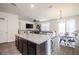 Open concept kitchen with island and dining area at 296 Spirit Landings Cir, Winter Haven, FL 33880