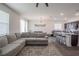 Open floor plan with gray sectional and kitchen at 296 Spirit Landings Cir, Winter Haven, FL 33880