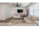 Living room with sectional sofa, TV, and built-in shelving at 296 Spirit Landings Cir, Winter Haven, FL 33880